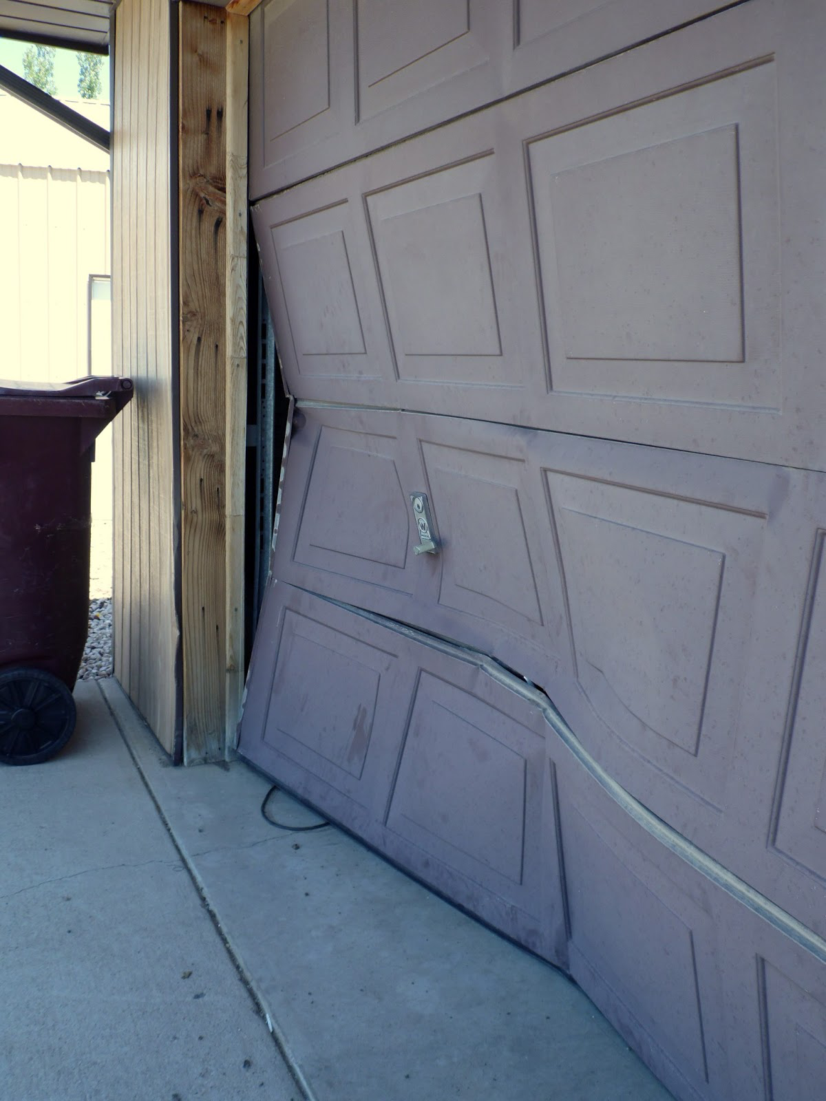 Technician repairing a broken garage door in Baltimore