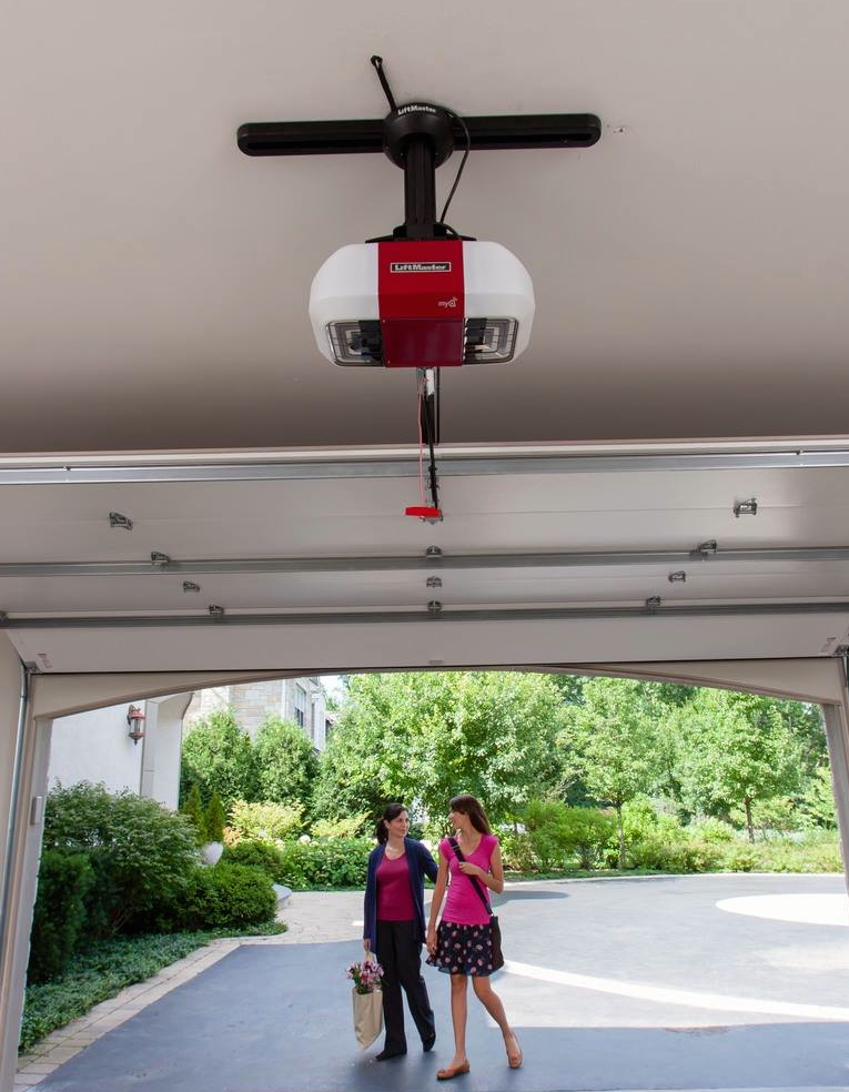 Technician installing a new garage door opener in Baltimore home