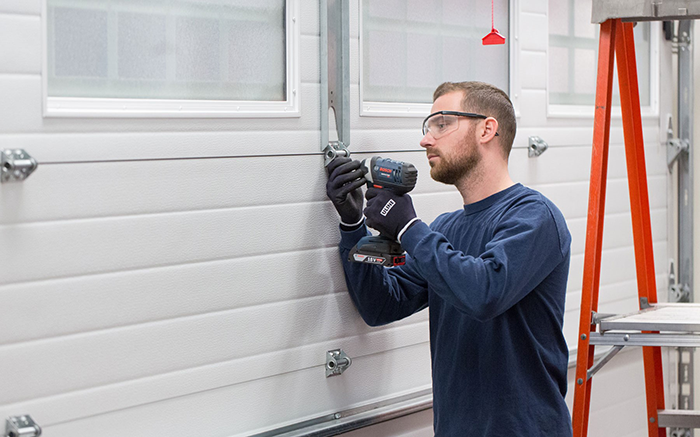 Technicians providing emergency garage door repairs, installation, and maintenance services to ensure safety and functionality, including broken spring repairs, opener replacements, and weatherproofing solutions.